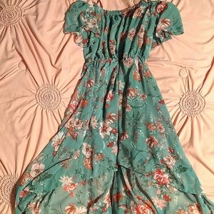 It is a mint green floral dress. Short in front long in the back. Size Small.